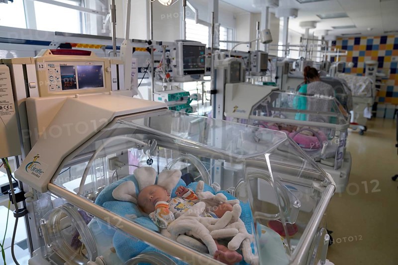 Newborn in incubator
