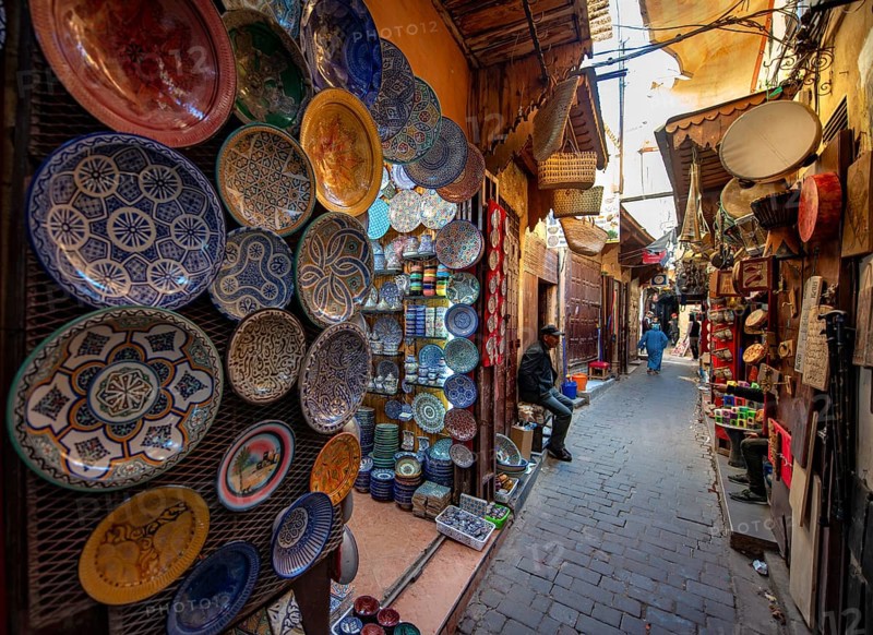 Colourfully painted plates and tiles