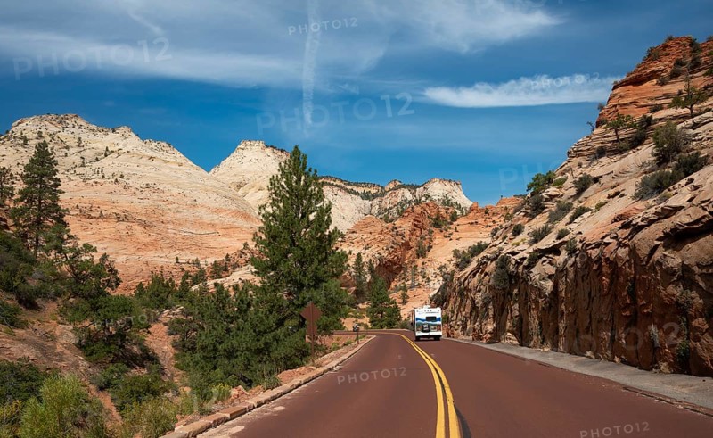 Caravan on road through mountain landscape