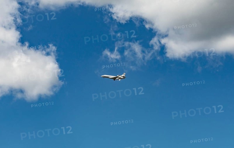 Business Jet flying in front of a blue cloudy sky
