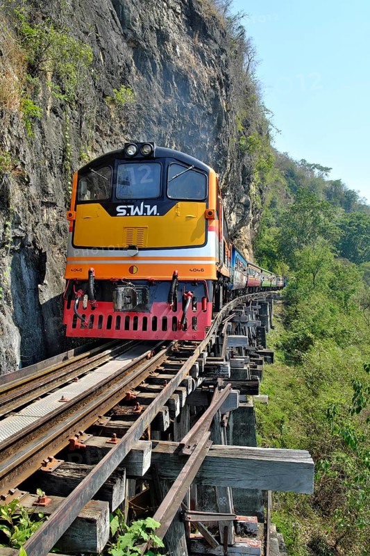 Passenger train runs on wooden bridge