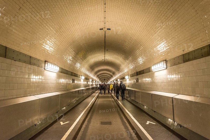 Pedestrians walk through the old Elbe tunnel