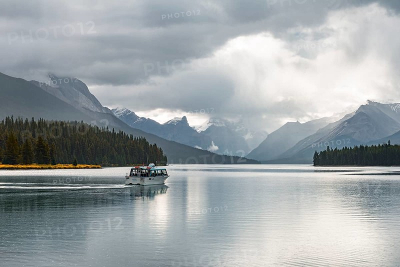 Excursion boat with tourists on Maligne Lake