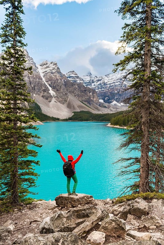 Hiker stands on the shore of a lake