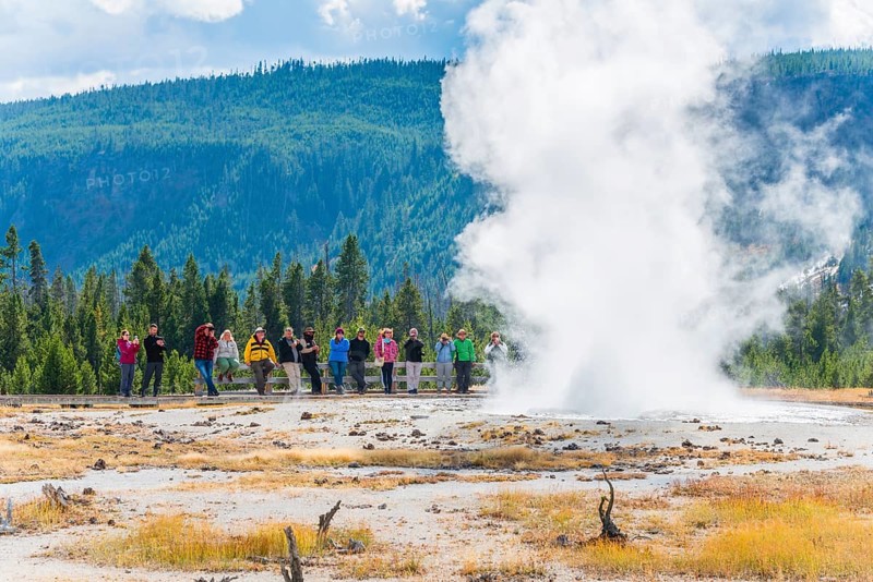 Tourists observe the eruption of the Geyser