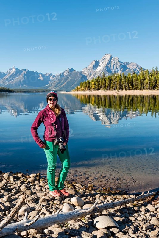 Young woman standing on the shore looking into the camera