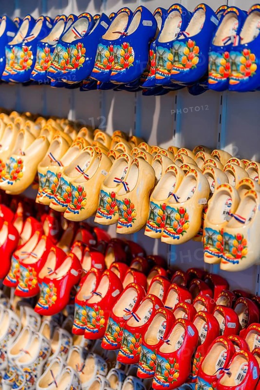 Traditionally colorfully painted Dutch wooden shoes on rack for sale