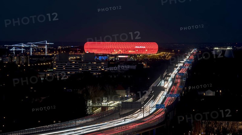 Red lit Allianz Arena at A9 motorway