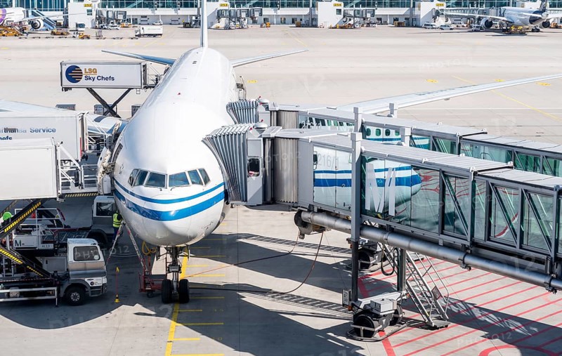 Passenger aircraft with docked passenger boarding bridge
