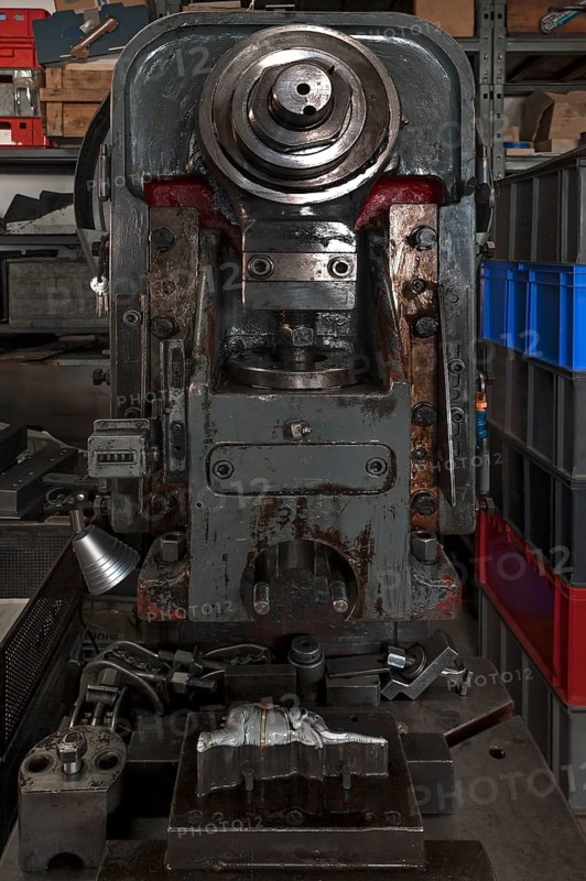 squeezing machine from the 1950s with mold and ready pressed elephants