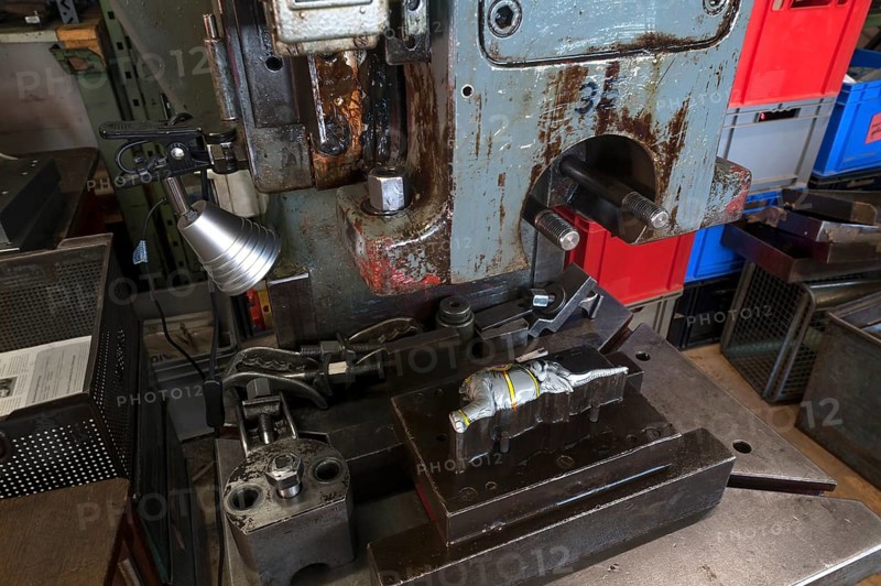 Squeezing machine from the 1950s with mold and ready pressed elephants