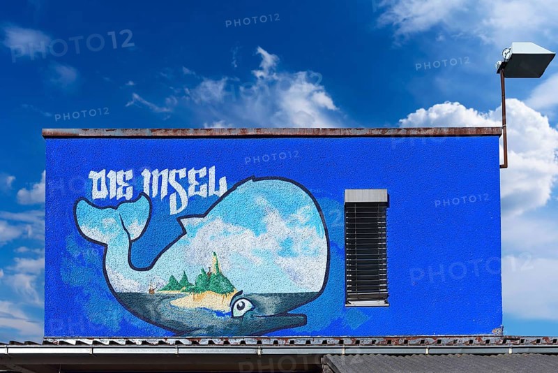 Graffiti whale figure on a building container