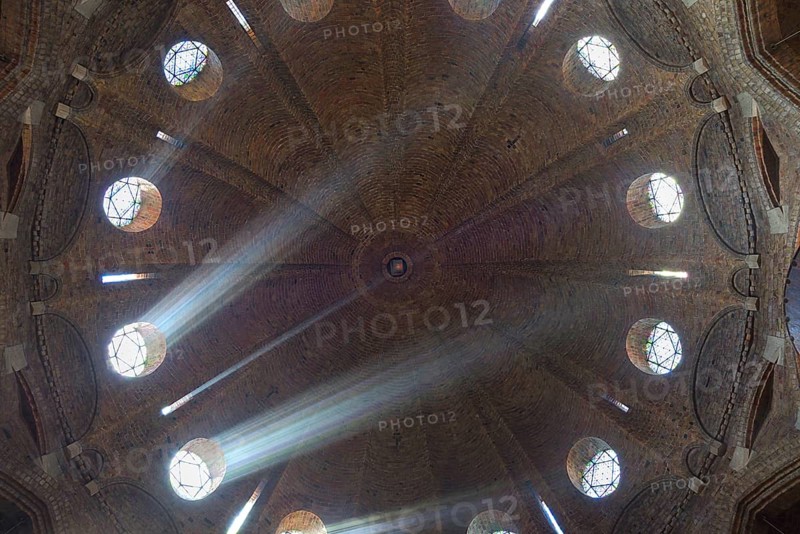 Rays of light shine through windows of the dome