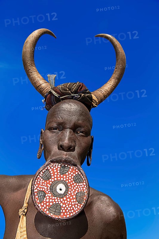 Woman with large lip plate and horns