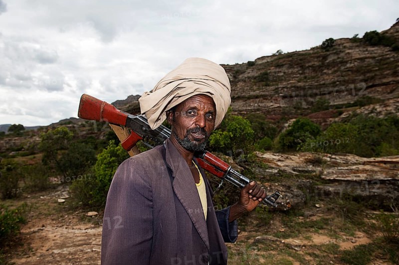 Local guide with Kalashnikov