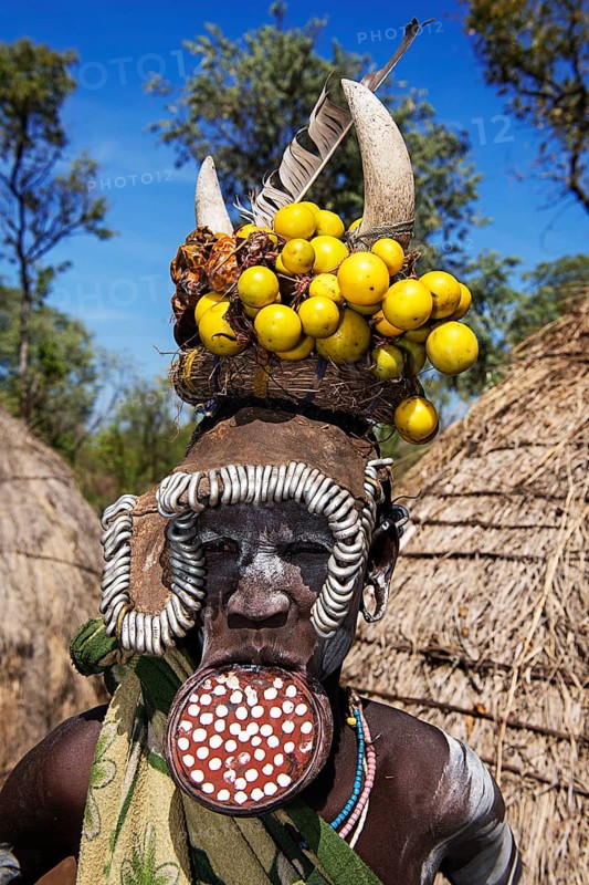 Woman with large lip plate and headdress