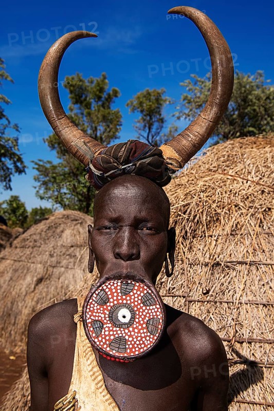 Woman with large lip plate and horns as headdress