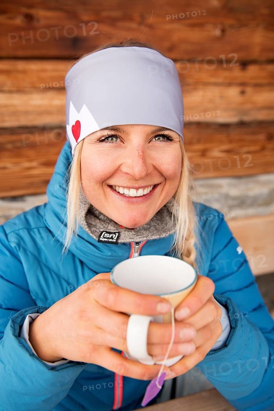 Female skier at the tea break at the hut