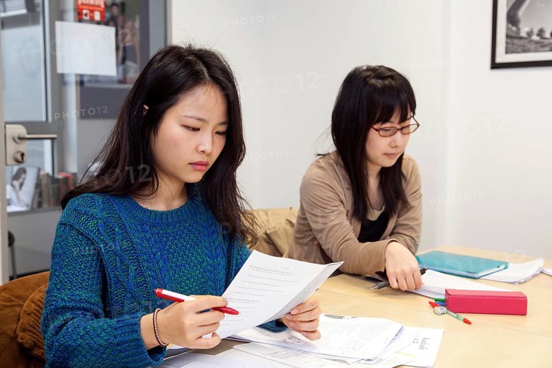 Foreign women in German lessons in an international class