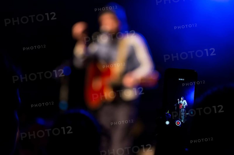 Concertgoer takes a photo with I-Phone at the concert of the Swiss singer and songwriter Shem Thomas live at the Schuur Lucerne