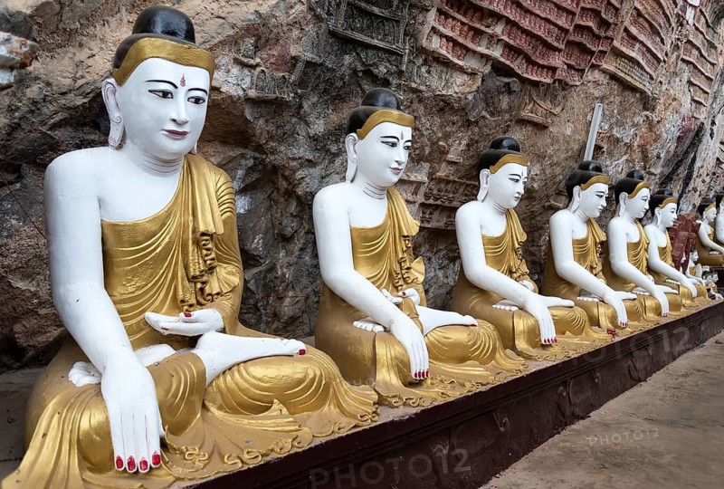 Line of Buddha statues at Kaw-goon Cave Temple