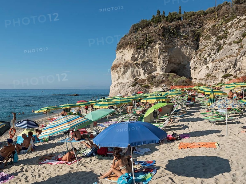 Many people with colorful sunshades at Lido Isola Bella Beach
