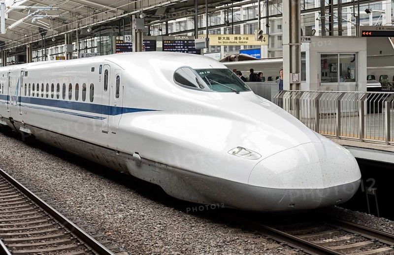 Shinkansen bullet train arriving to railway station