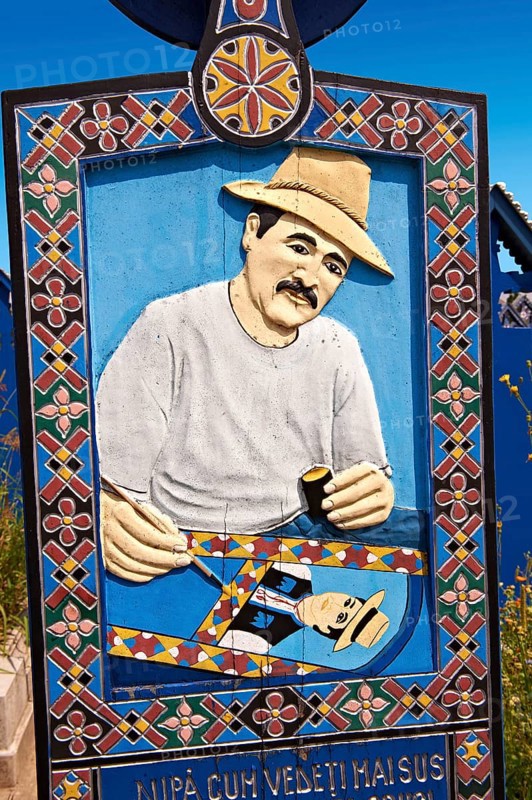 Tombstone showing a man painting the tombstones