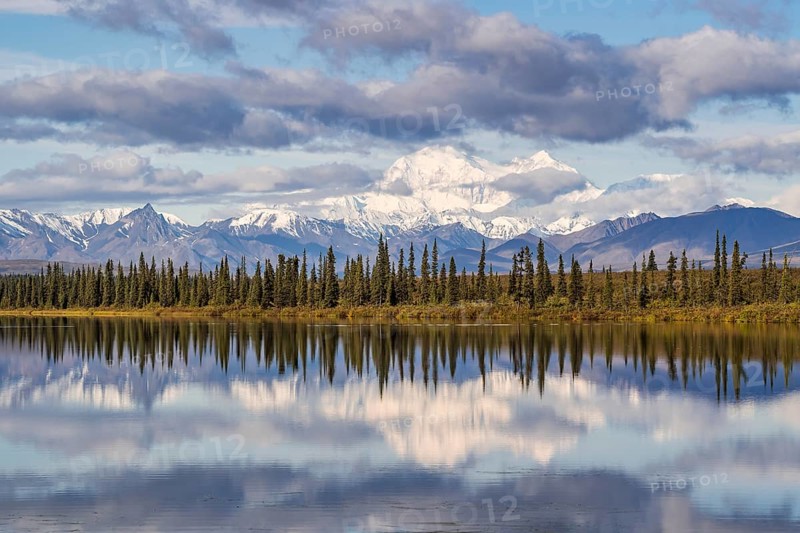 Snowy mountain Denali reflected in the lake with cloudy sky
