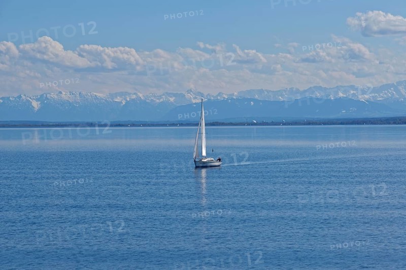 Lake Ammer with sailboat and the snow-covered Alpine peaks in the background