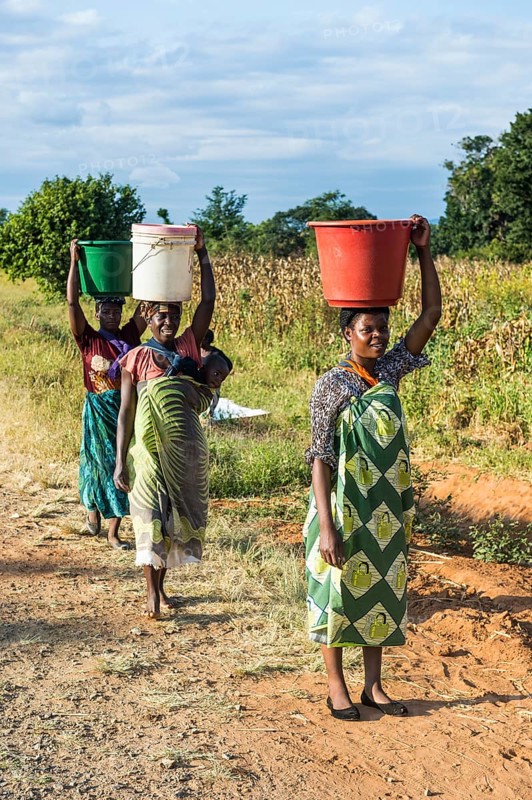 Local women carrying buckets on their head