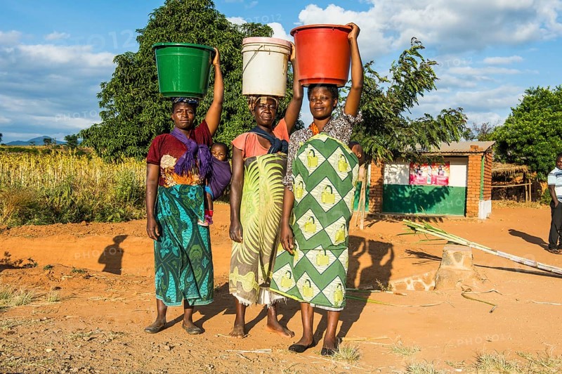 Local women carrying buckets on their head