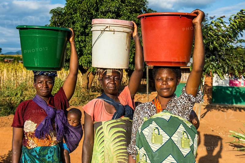 Local women carrying buckets on their head