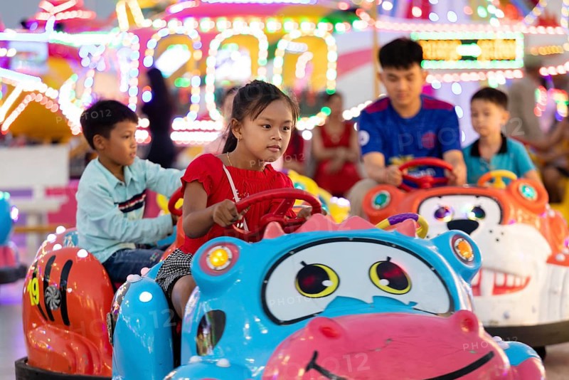 Children driving bumper cars at Koh Pich theme park
