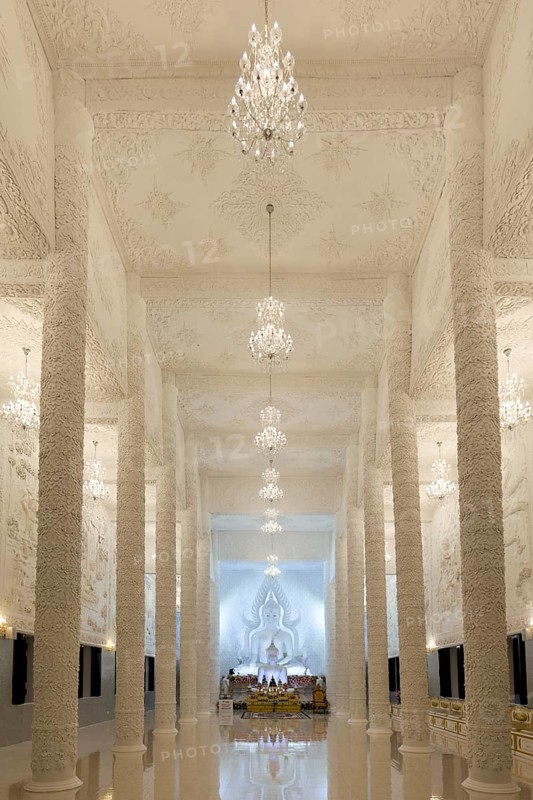 Ornamental columns in the white prayer hall with Buddha statue