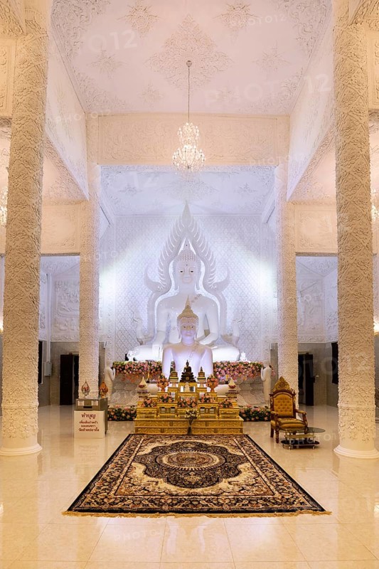 Ornamental columns in the white prayer hall with Buddha statue