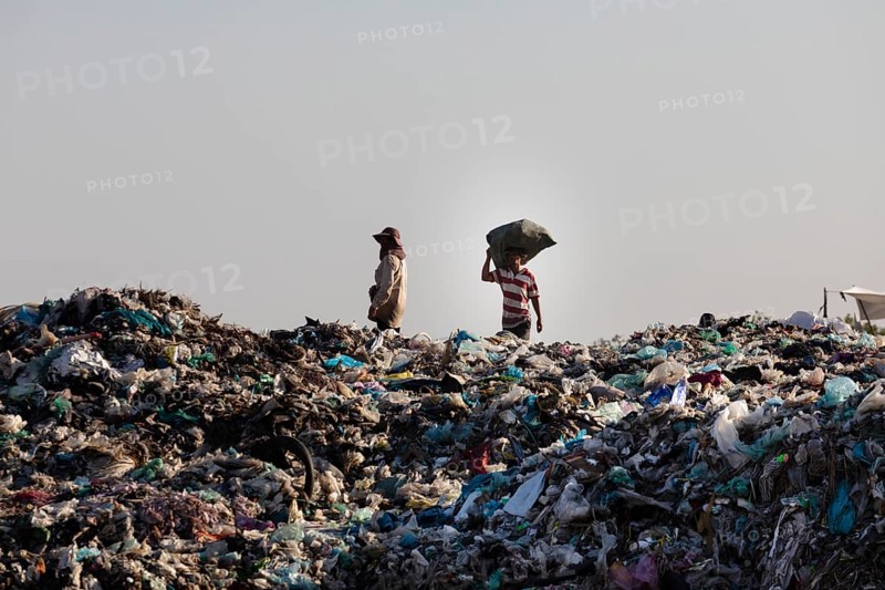 Garbage collector at garbage dump