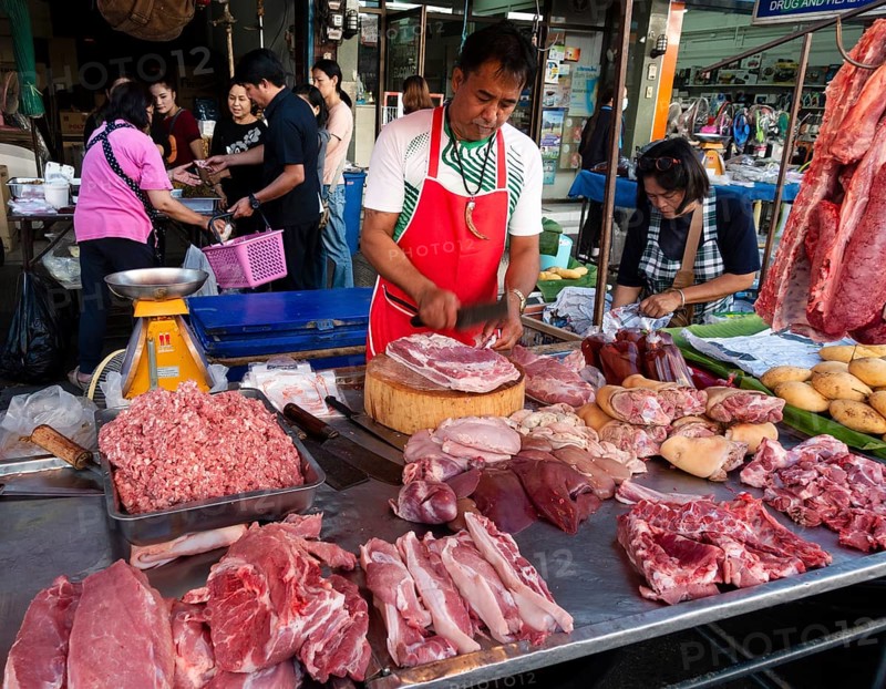 Seller with meat on the market