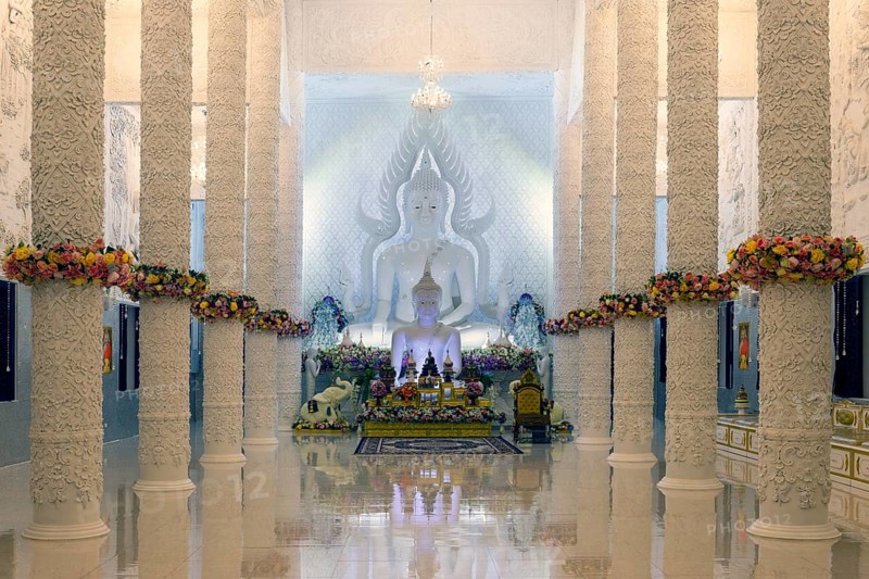 Ornamental columns in the white prayer hall with Buddha statue