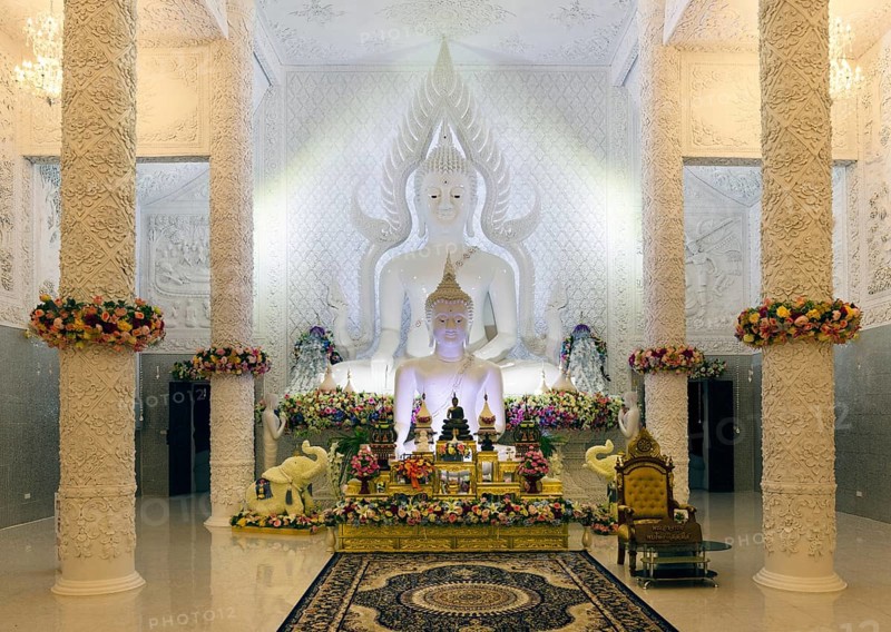 Ornamental columns in the white prayer hall with Buddha statue