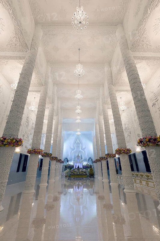 Ornamental columns in the white prayer hall with Buddha statue