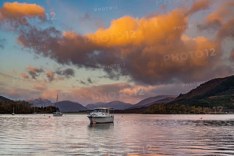 Boats with Loch Linnhe at sunrise with coloured clouds