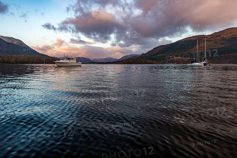 Boats with Loch Linnhe at sunrise with coloured clouds