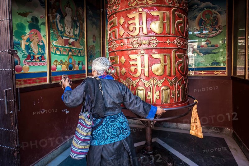 Buddhist turns to prayer wheel