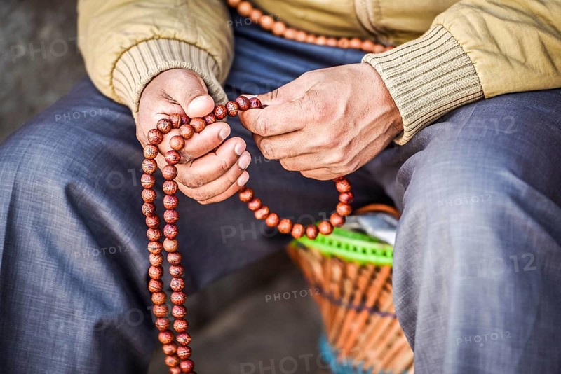 Hands with Buddhist prayer chain