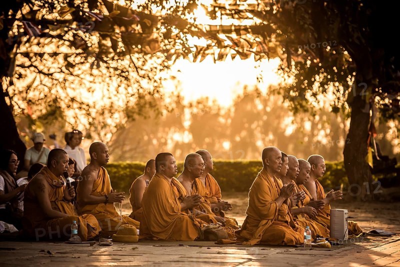 Buddhist pilgrims pray at Bodhi tree at Mayadevi temple