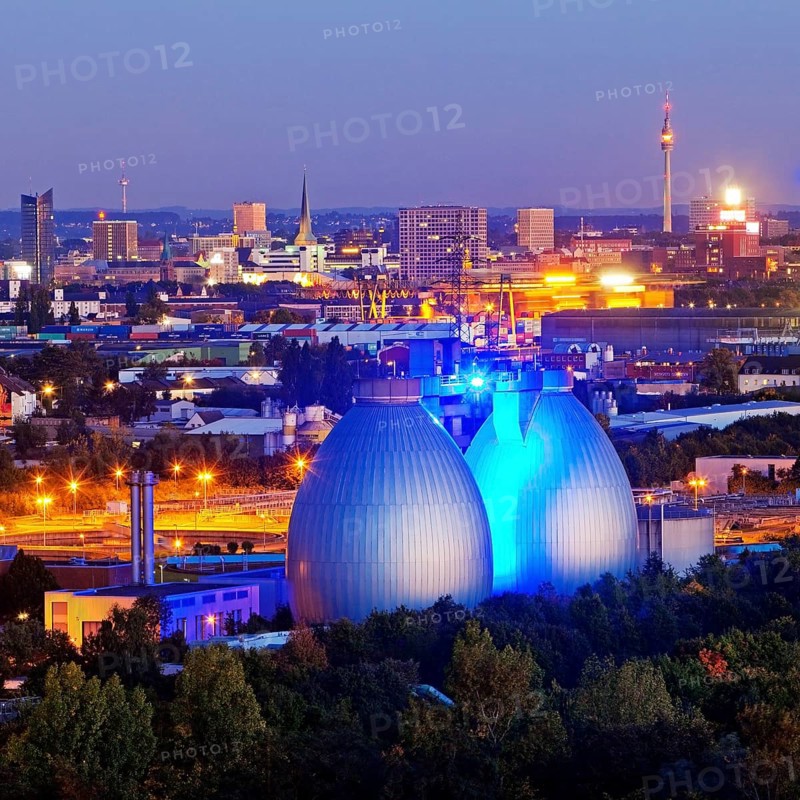 City viwe with the illuminated digesters of WWTP Dortmund Deusen II