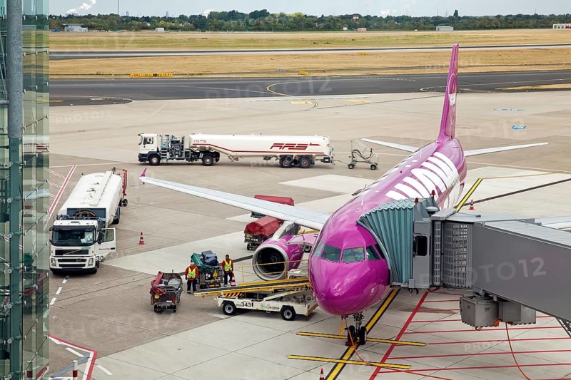 Airplane at the passenger boarding bridge on the runway