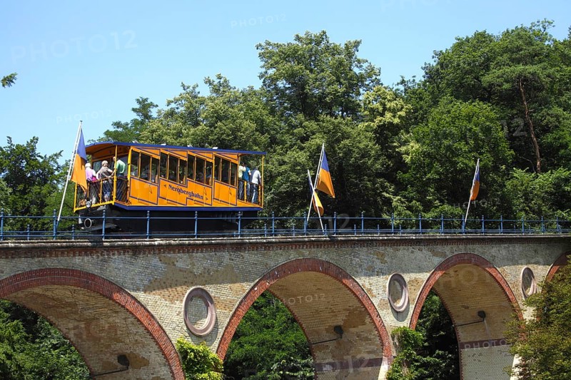 Waggon of Nerobergbahn drives over arch bridge