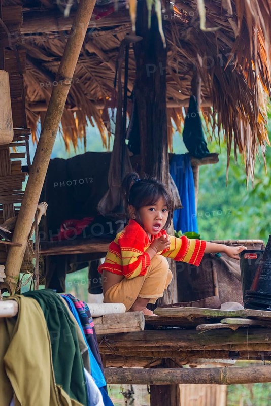 Young girl sitting in a hut